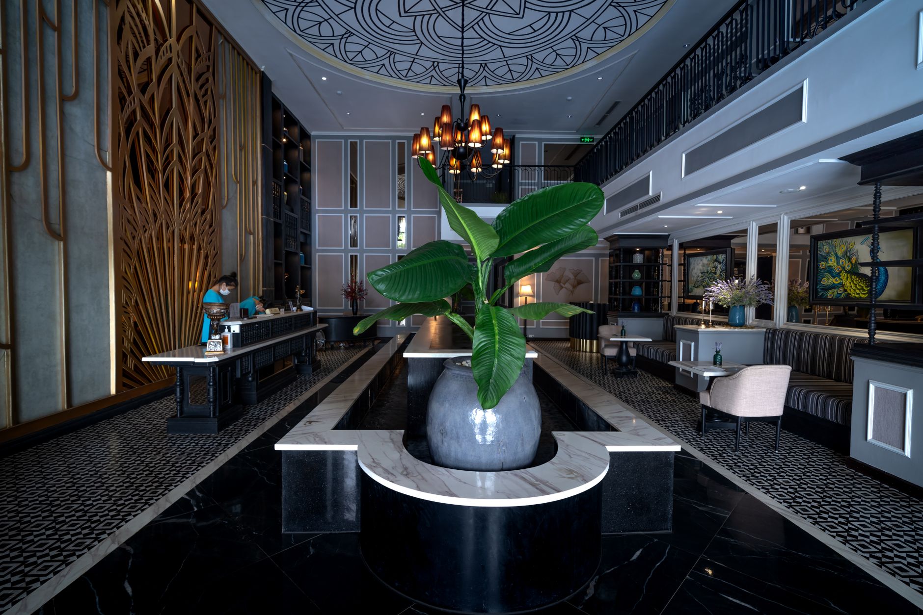 An elegant hotel lobby with marble floors and a chandelier